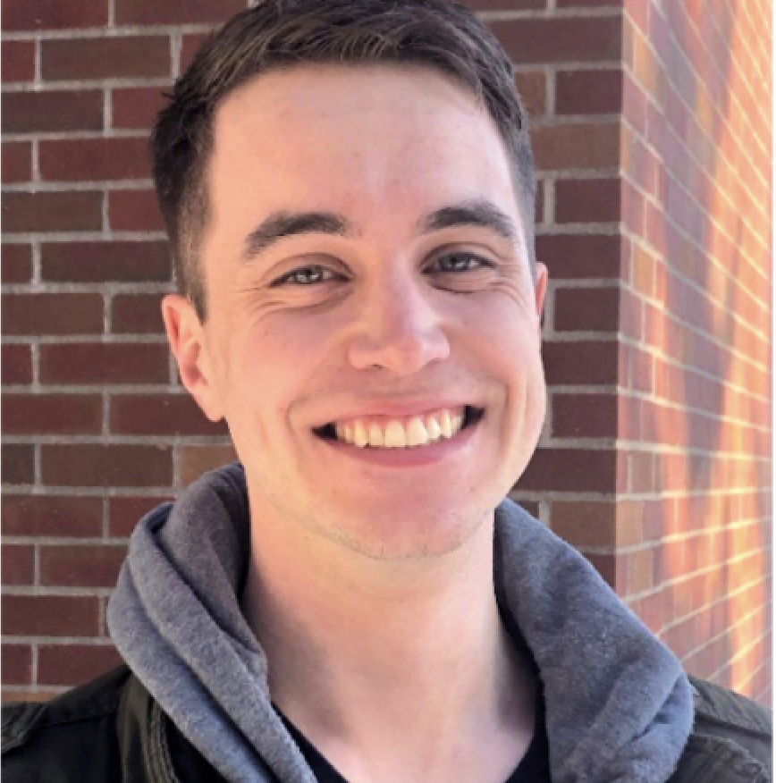 Carson Powers standing near a red brick university building in winter