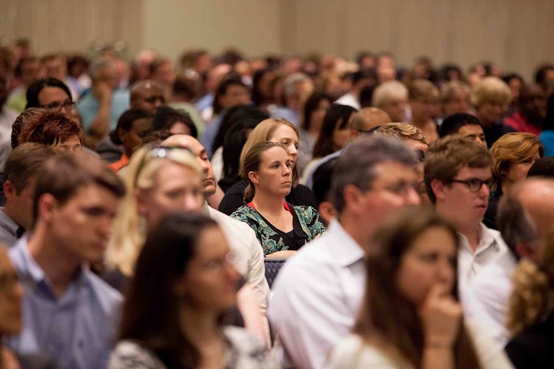 Conference attendees listen to a speaker.